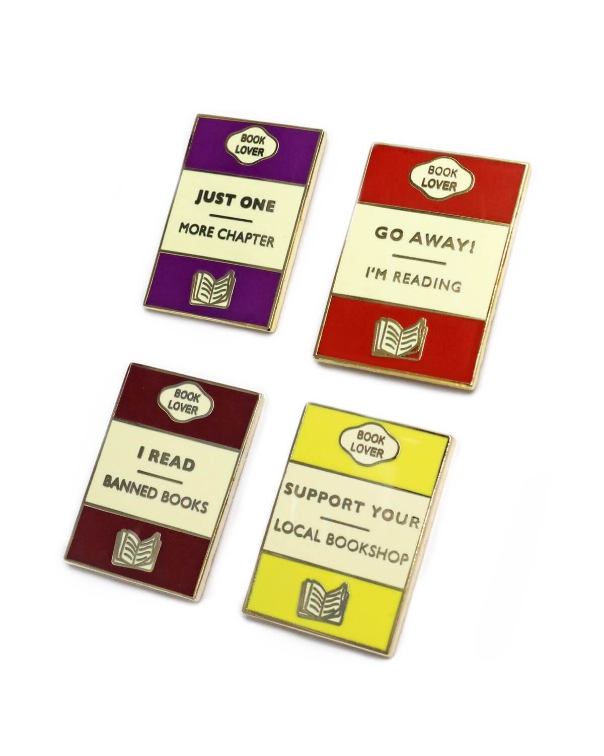 A set of 4 pin badges featuring a classic book design