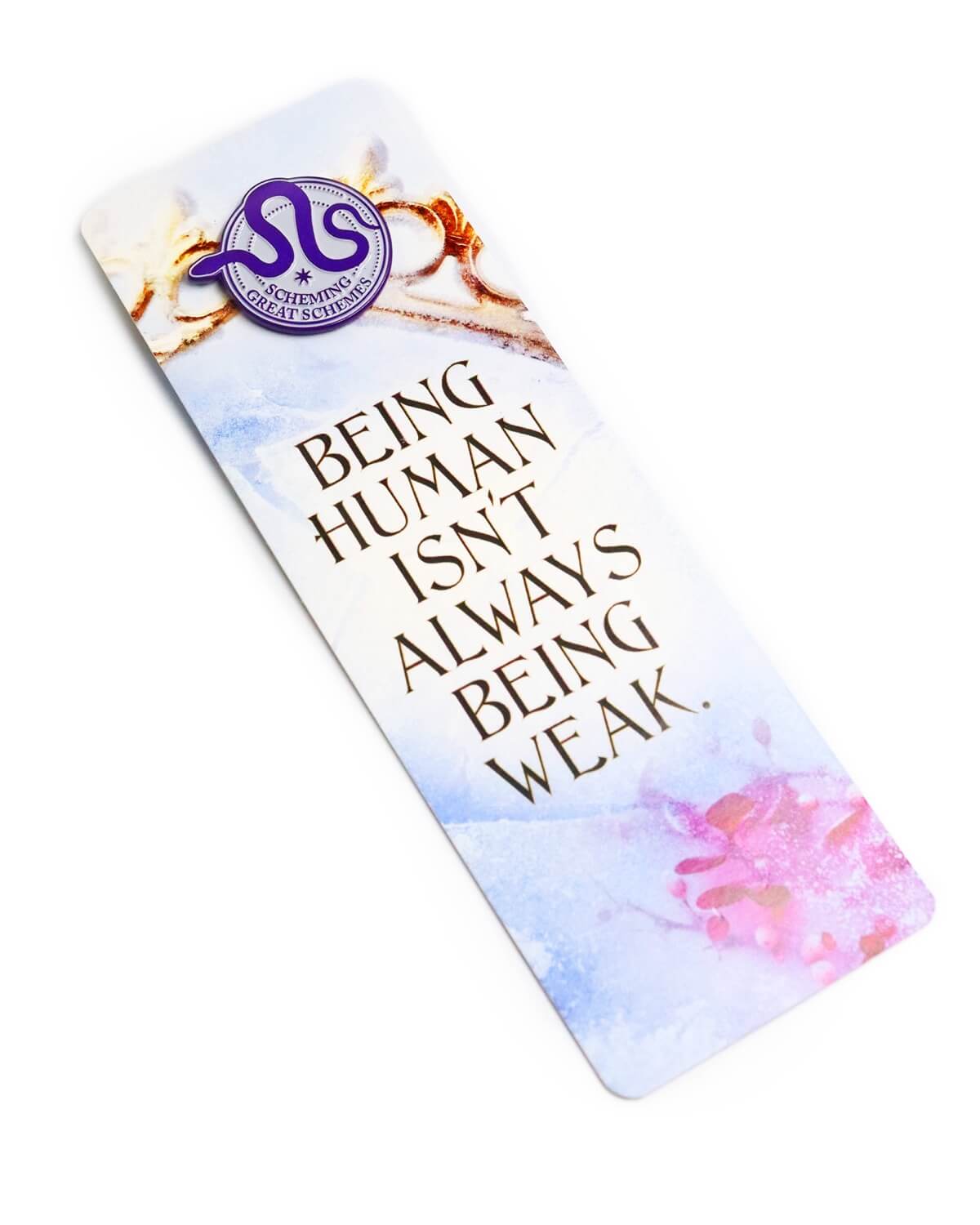A pin badge attached to a bookmark.