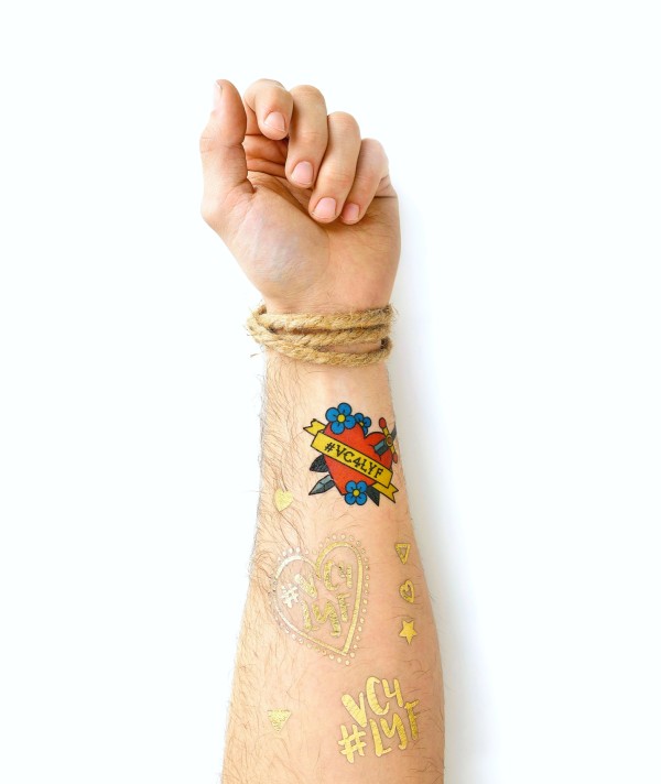 Metallic tattoos temporary. The arm features golden tattoos that can be easily removed.