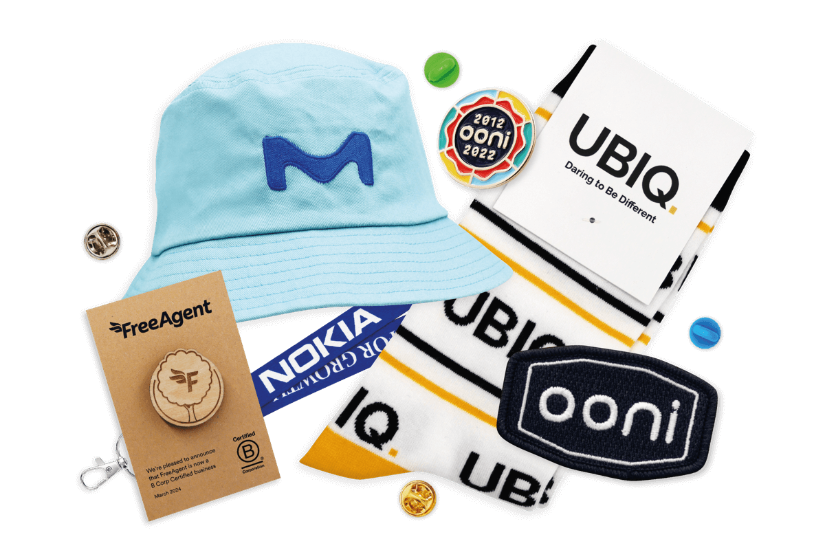 A collection of mixed merch featuring socks, pin badges, lanyards, patches and hats.