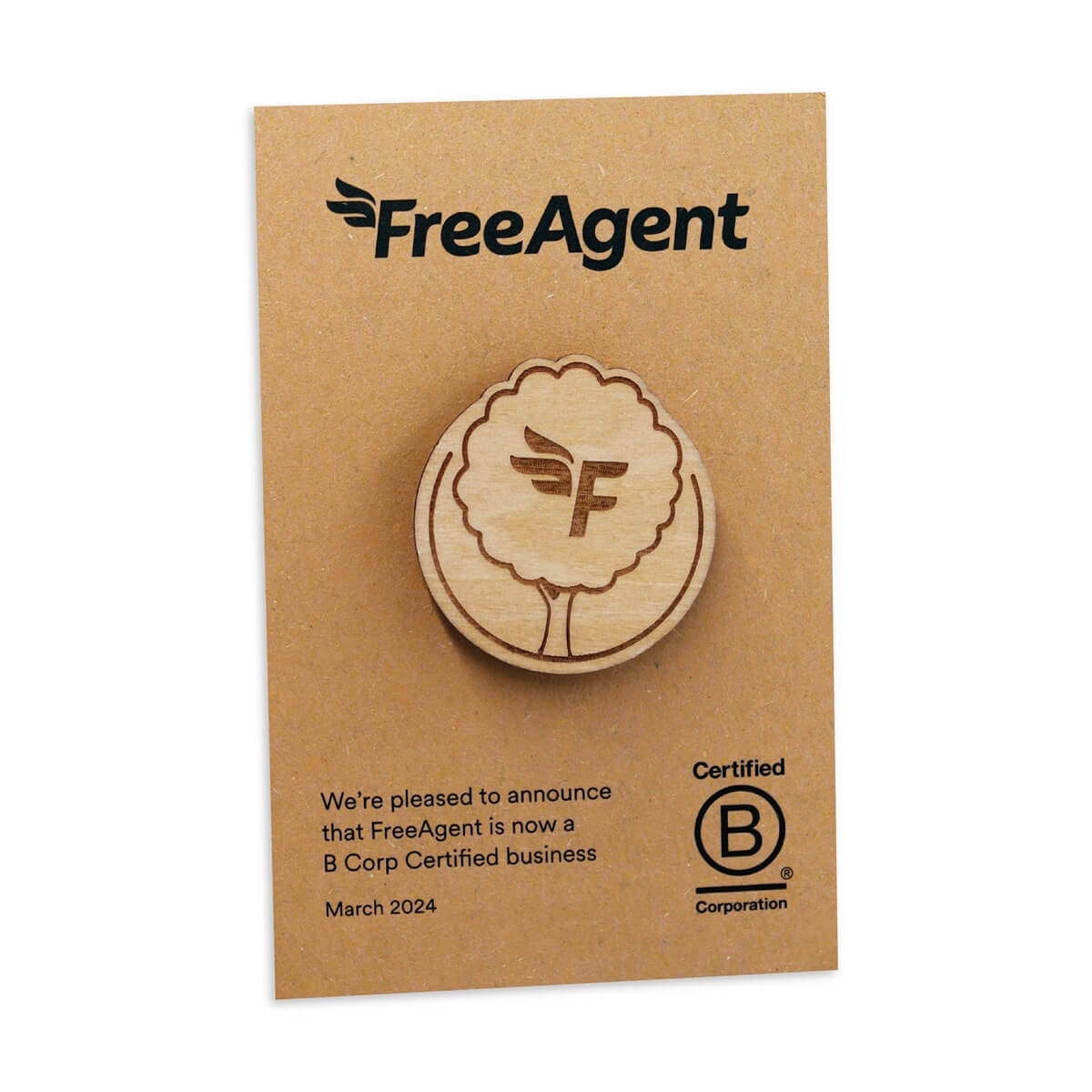 A wooden pin badge on a backing card for FreeAgent