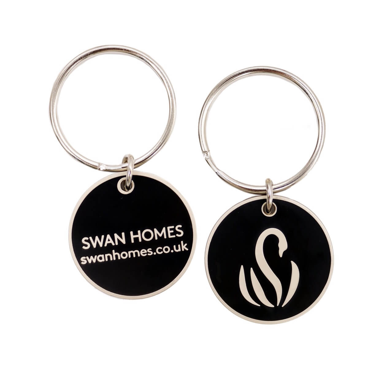 The front and back of a keyring featuring the Swan Homes branding