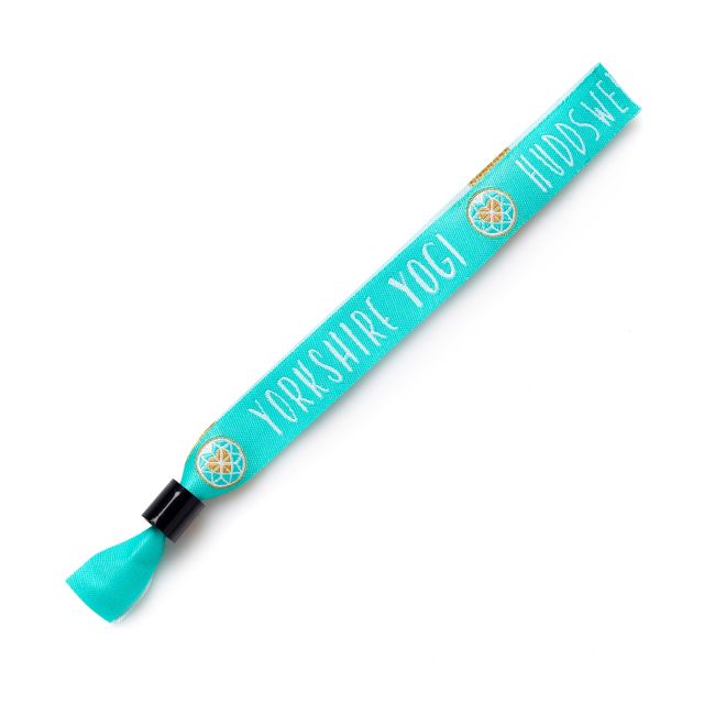 A teal cloth custom wristband with the words 