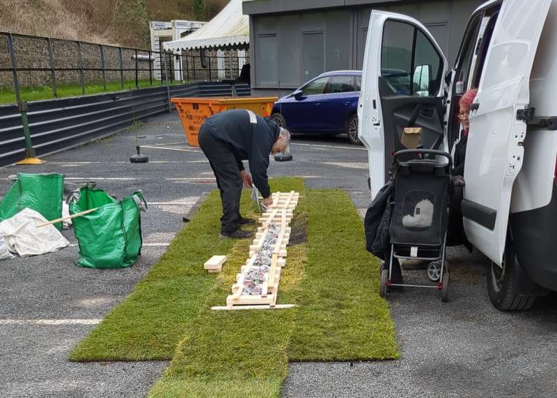 A firewalking expert prepares the wood that will form the base of the flaming fire walk