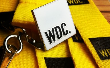 WDC hard enamel badge with yellow polyester lanyard and black silkscreen print logo.