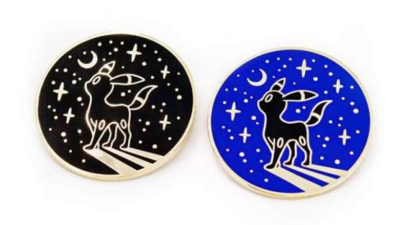 Two enamel pin badges, they have the same design small animal looking up at the starry night sky! One badge has a black background, the other has blue.