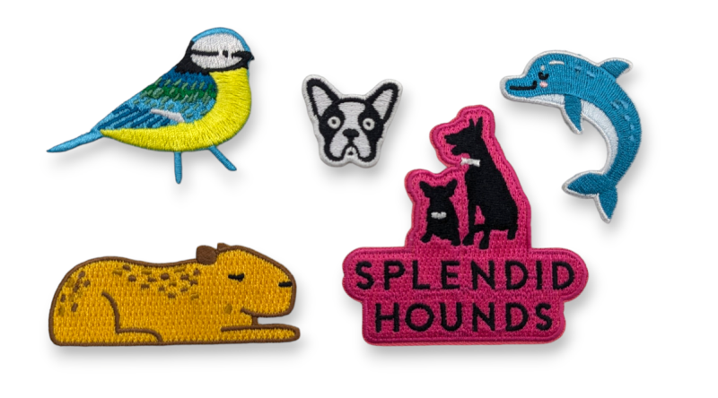 A collection of embroidered patches that feature a blue tit, a french bulldog, a dolphin and a weird sleeping gnu type thing.