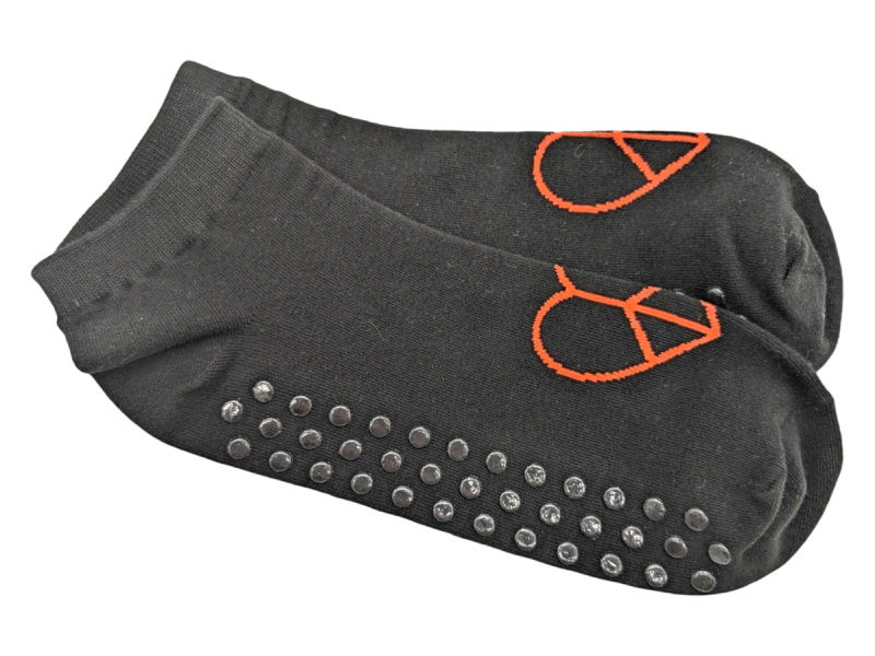 Black anti-slip ankle socks with black rubber grip soles and a red love heart logo on the top.