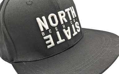 A black baseball cap with North State embroidered on the front in white thread.