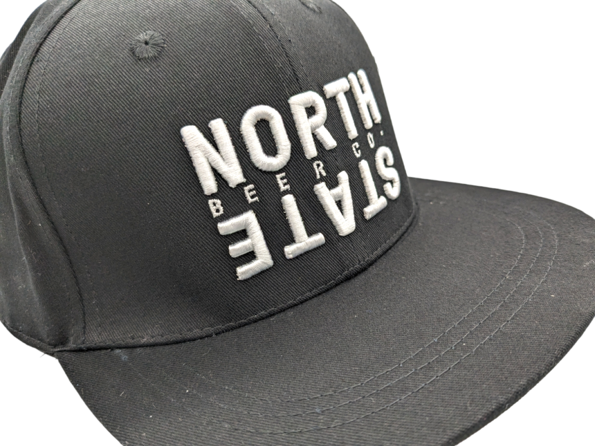 A black baseball cap with North State embroidered on the front in white thread.