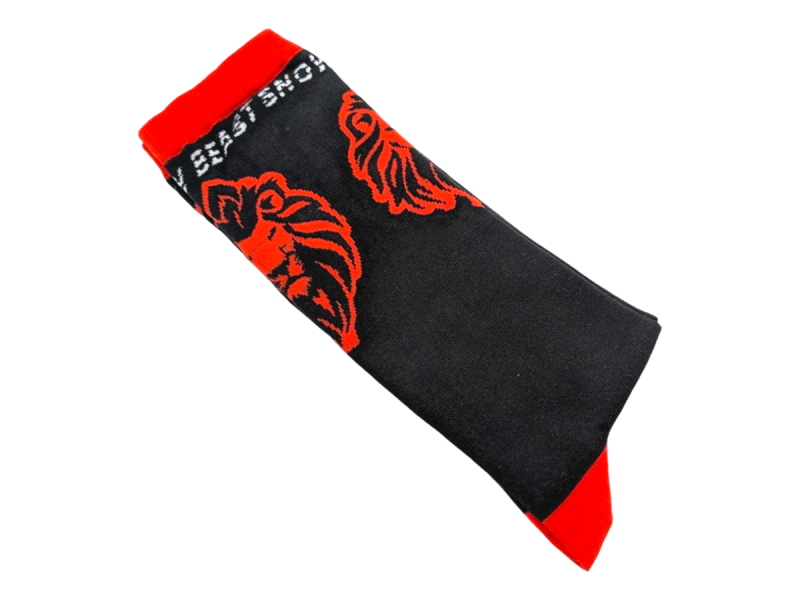 Black and red socks with a red lions head knitted into them.
