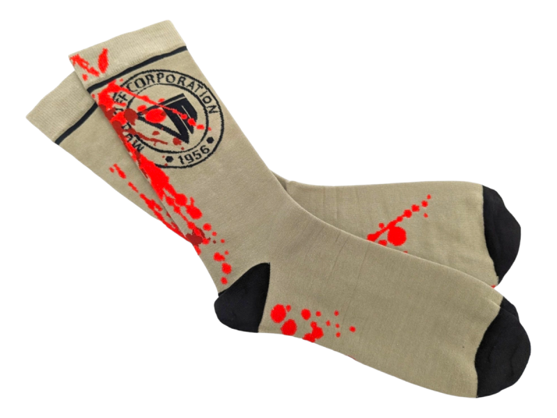 Beige socks with black heels and toes a school logo and fake blood knitted into the fabric.