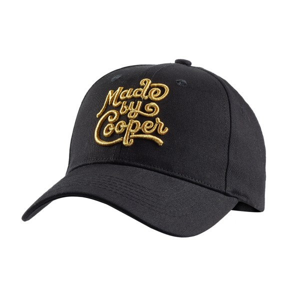 A black curved peak custom baseball cap with the MbC logo embroidered on the front in gold thread.