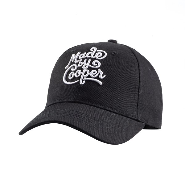 A black curved peak custom baseball cap with the MbC logo embroidered on the front in white thread.
