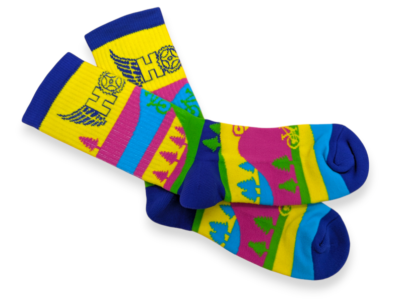 A seriously vibrant pair of custom socks. They show a basic landscape design which really stands out thanks to the bright pinks, yellows, blues and greens.