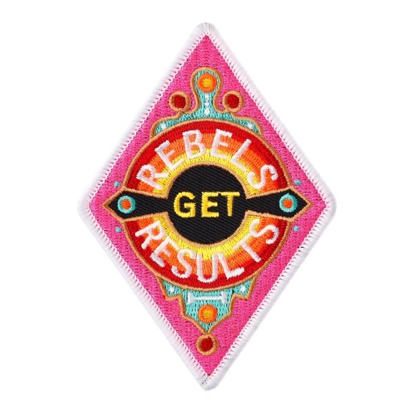 A diamond shaped embroidered cloth badge. It has vibrant pink, orange, and yellow colours, and