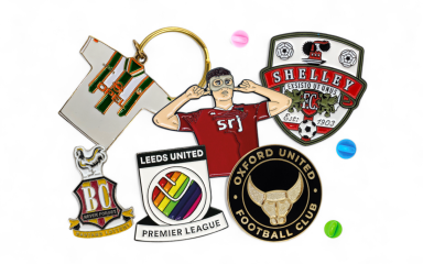 A collection of football badges enamel pins and keyrings.