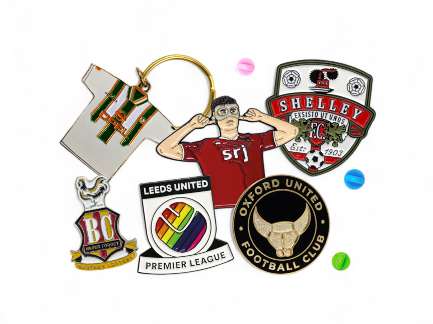 A collection of football badges enamel pins and keyrings.