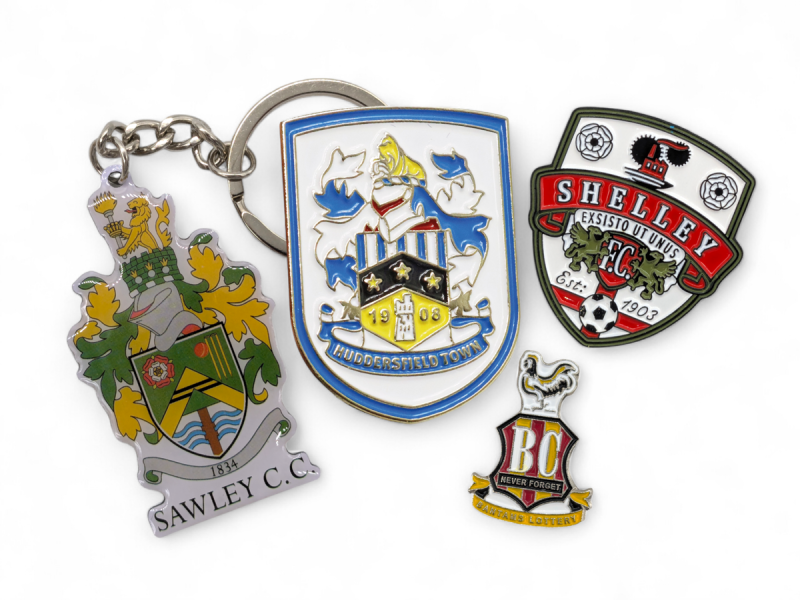 Football crest and logo pin badges and keychains.