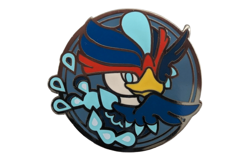 A circle pin badge with a cartoon bird and bright colours.