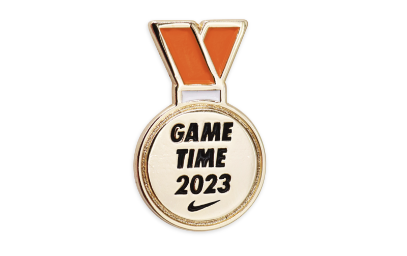 A collection of Nike pin badges in the shape of a medal with the words 