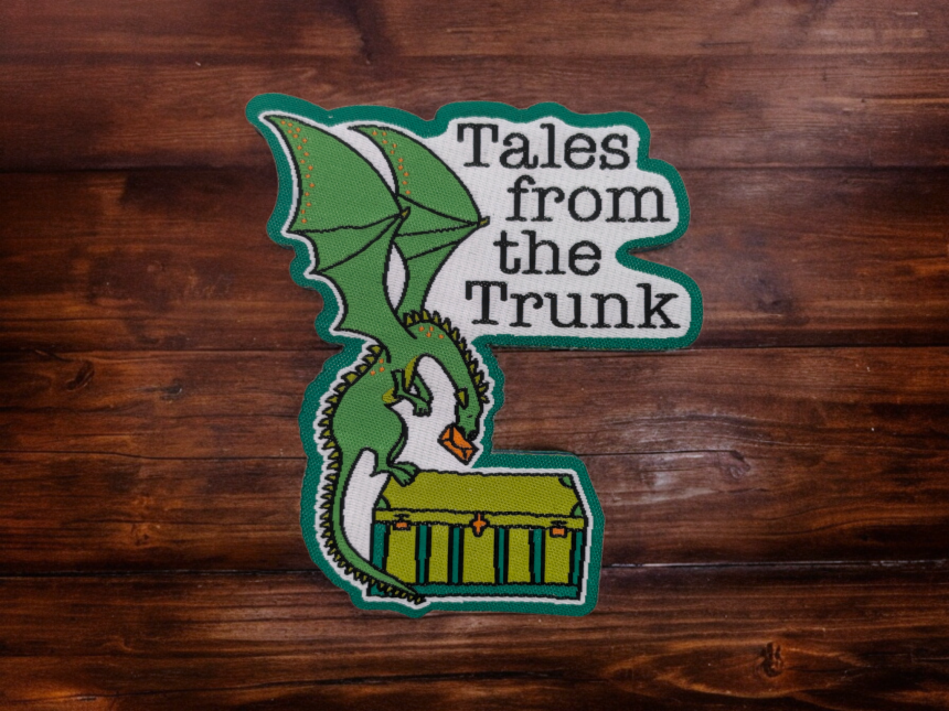 A dragon woven patch with the words Tales from the Trunk written on it.