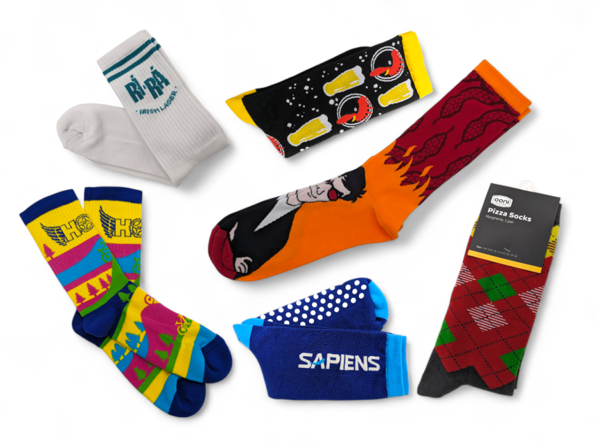 A collection of brightly coloured custom socks with a wide range of funky designs and branding.