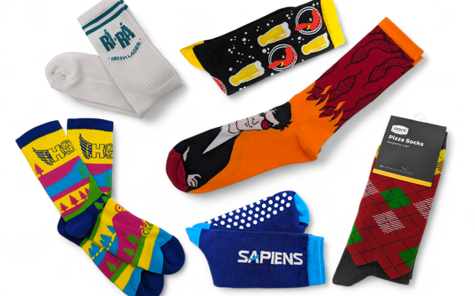 A collection of brightly coloured custom socks with a wide range of funky designs and branding.