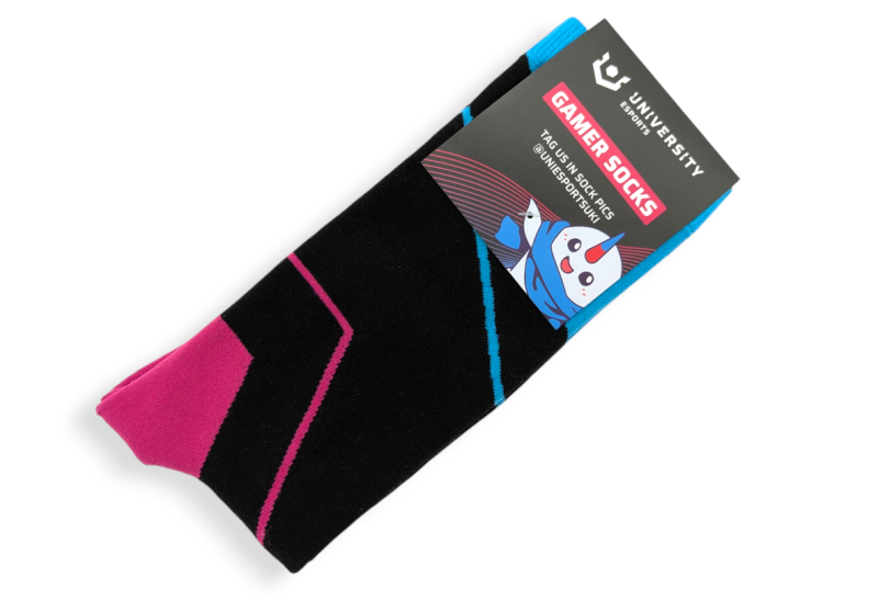 A pair of black custom socks with pink and blue trim that are packaged with a cardboard header that has the words 