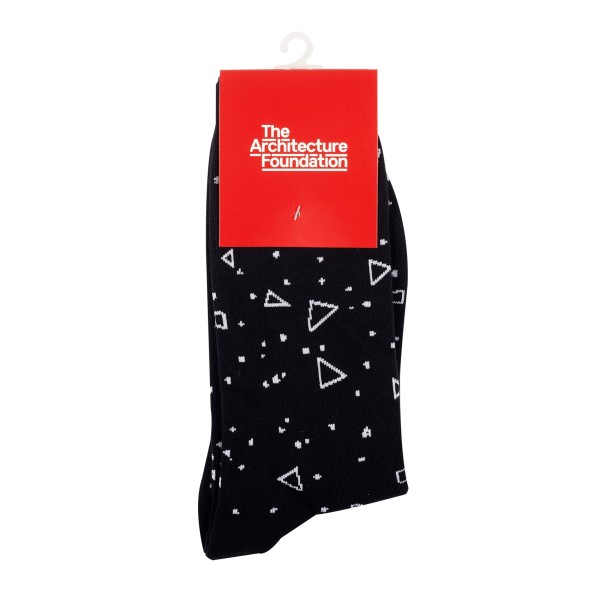 A pair of black custom socks with white stitched design. The socks are held together with a red branded card that reads