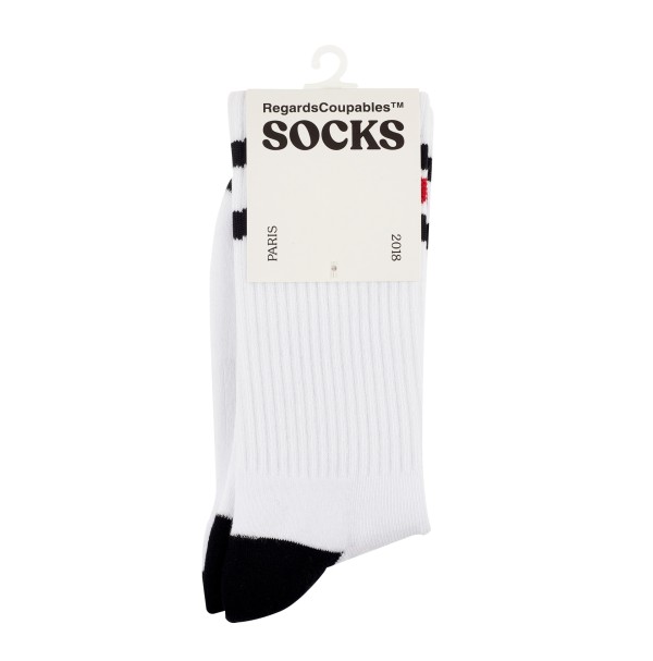 A pair of white bodied sports socks folded and attached to a white branding card that reads