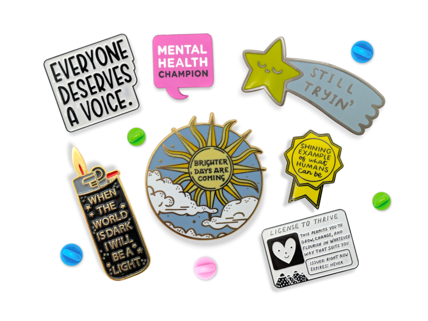 A collection of enamel pins with designs that promote mental health positivity.