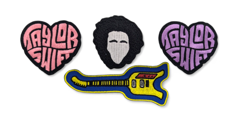 Two Taylor Swift love heart patches, an embroidered guitar patch and the outline of Bob Marley's head.