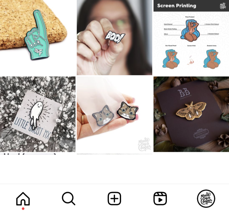 A screenshot of Made by Cooper's Instagram grid showcasing some beautiful enamel pins they've made for clients including a cartoon ghost, tiny cat badge, a detailed butterfly and a green pointy finger.