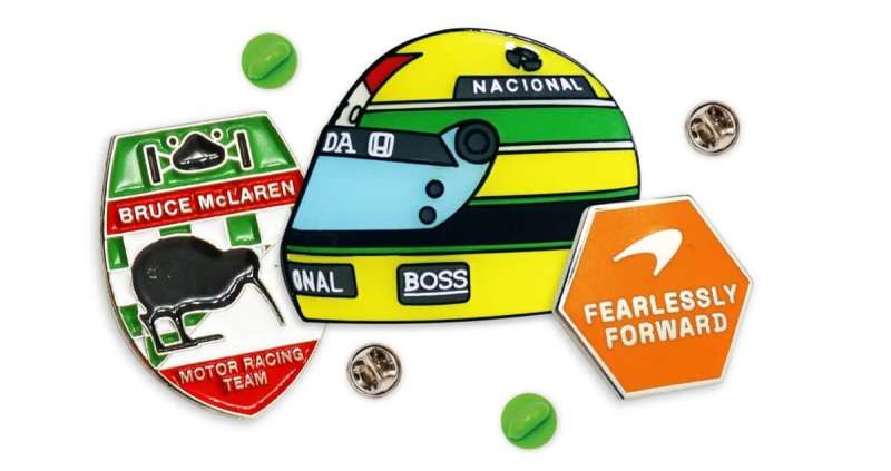 Some F1 pins showcasing Senna's helmet and two McLaren logos.