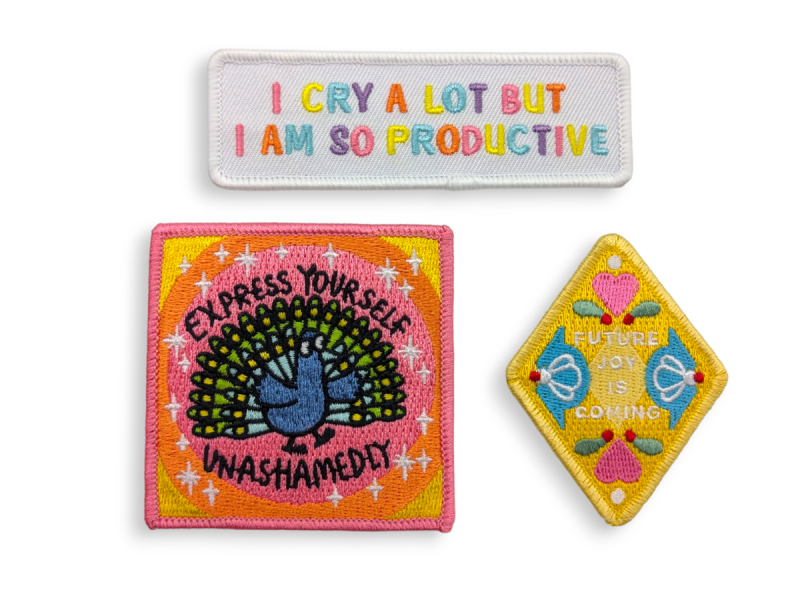 Three embroidered patches that display motivational quotes and sayings.