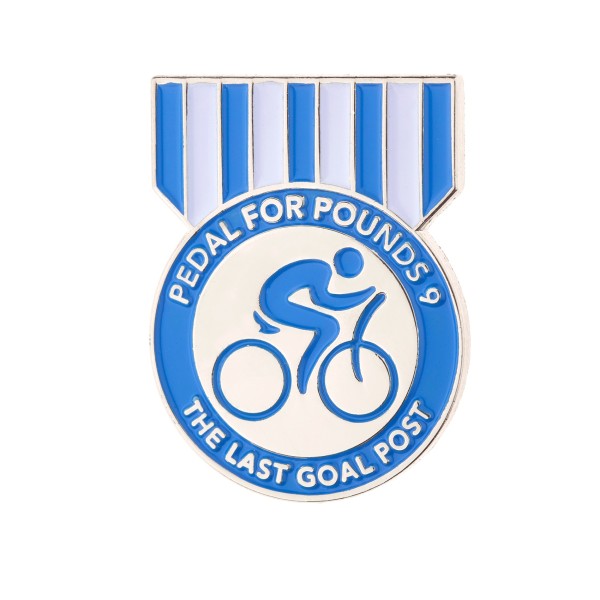 An enamel pin in the shape of a medal for the cycling charity event, pedal for pounds.