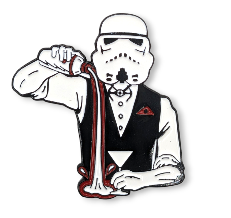 A pin badge of a storm trooper dressed in a suit serving a cocktail. It's very funny.