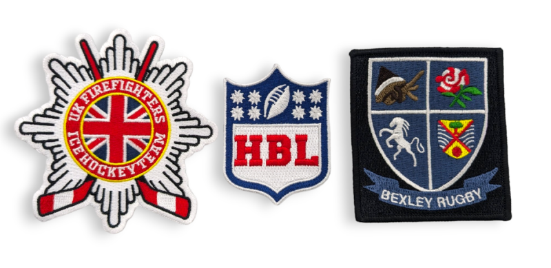 Three embroidered patches representing local sports clubs and teams.