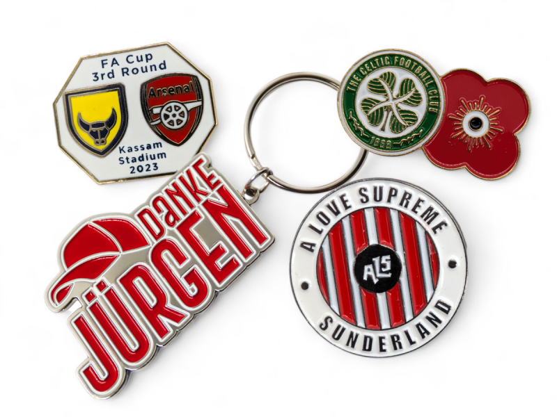 Arsenal, Oxford and Liverpool badges and keyrings.