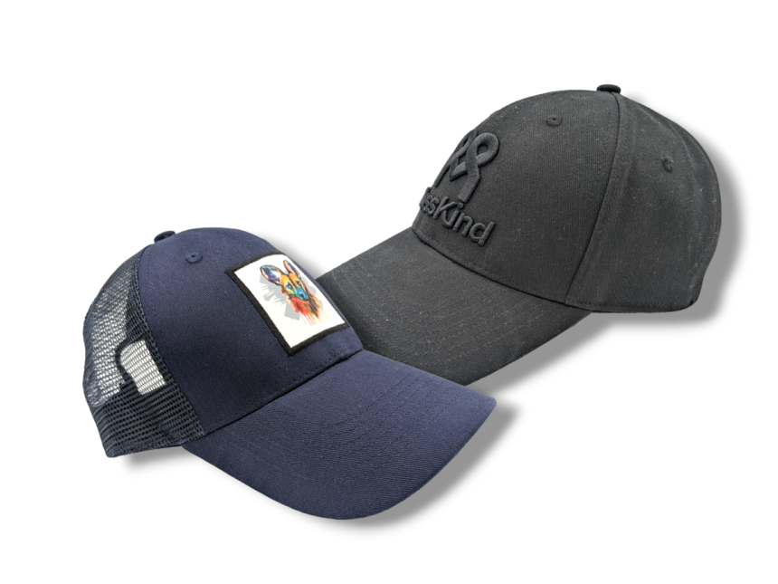 A black baseball cap and blue trucker hat side by side to compare the differences between the two.