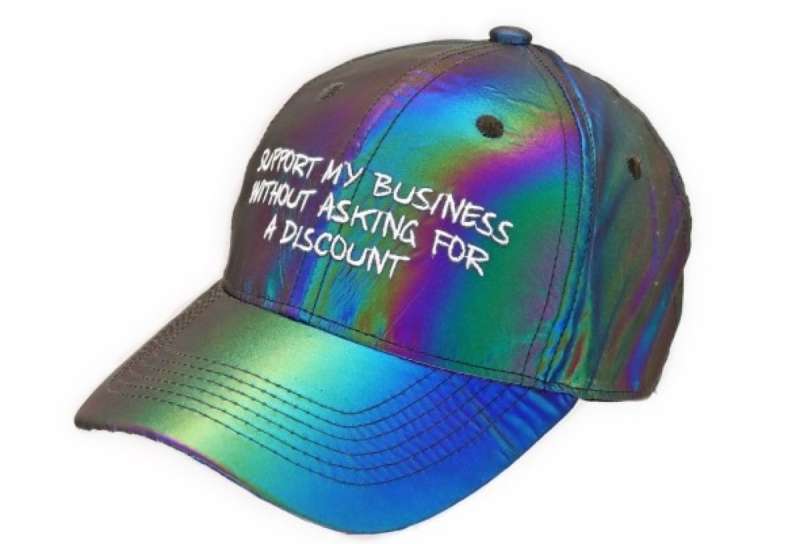 A funky baseball cap made from iridescent material that says 