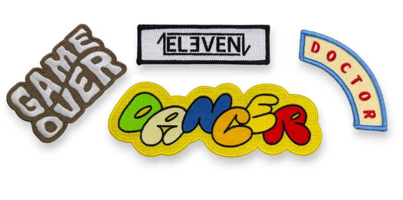 A small collection of typographical embroidered patches that say Game Over, Dancer, Doctor, and Eleven.