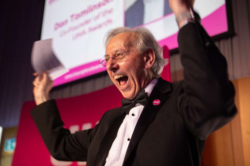 A man with grey hair celebrate the announcement of an Unsung Hero award winner.