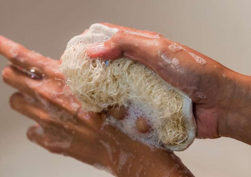 A pair of hands cleaning themselves in warm soapy water.