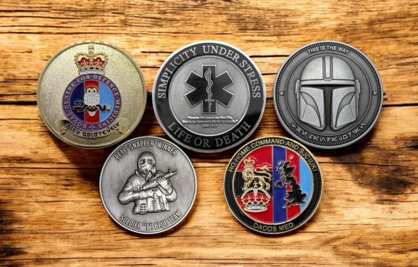 A collection of five challenge coins for military groups, emergency services, and for collecting.