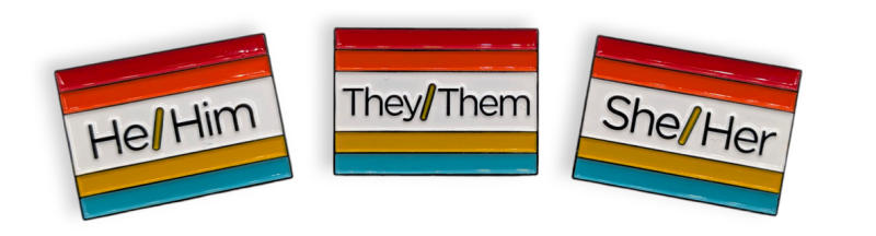 Three rainbow flag badges with the pronouns He/Him, They/Them, She/Her pronouns.