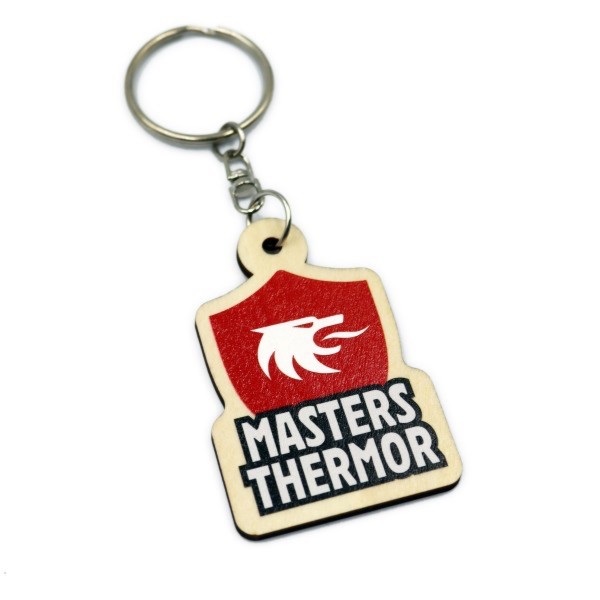 A custom wooden keyring featuring a red shield and white griffin's head and the words Masters Thermor.