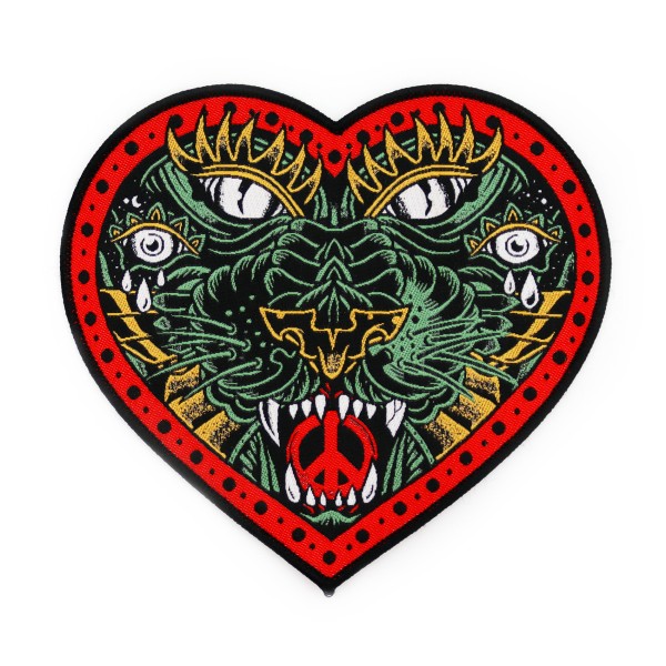 A custom patch in the shape of a love heart that contains an intricate tribal design of a panther.