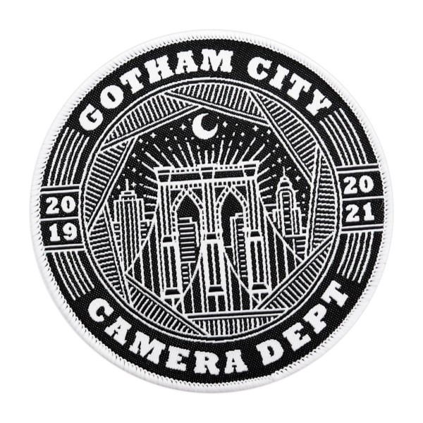 A circular custom patch featuring the skyscape of Gotham City with the words